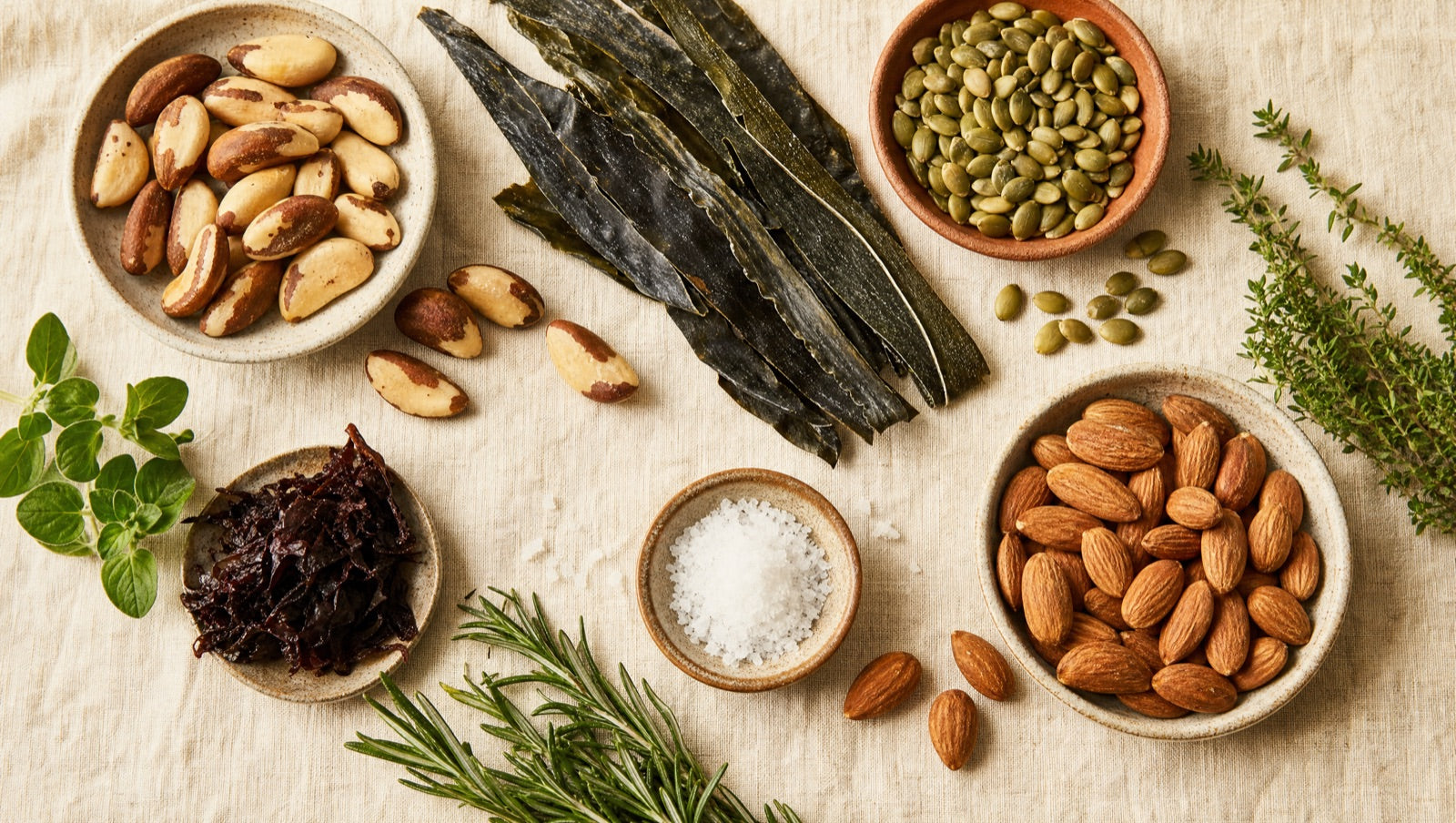 Whole-food sources of metabolism and thyroid nutrients arranged on cream linen
